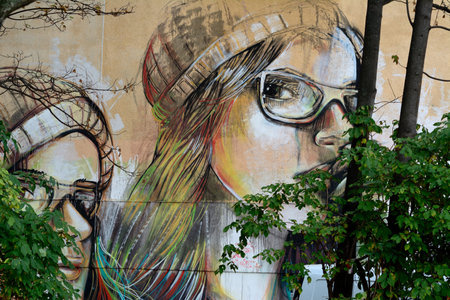 Two face of girls graffiti behind trees, peeking out