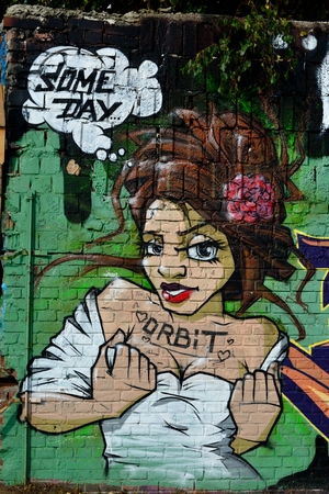 Sexy latino girl graffiti on a brick wallのeditorial素材