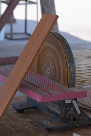 Electric powertool on a workbench with a piece of wood