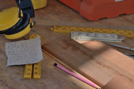 Rulers and pencil on a workbench with earrmuffsの写真素材