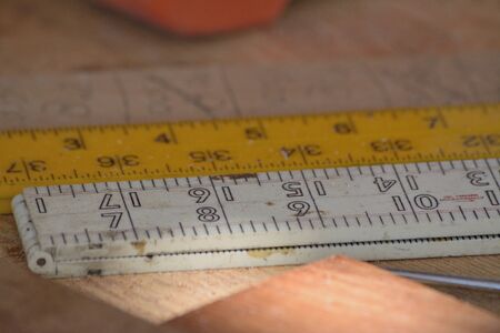 Different rulers with measurements on a workbenchの写真素材