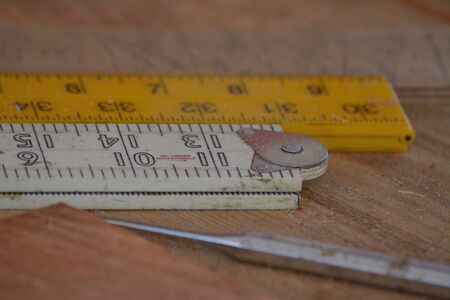 Different rulers with measurements on a workbenchの写真素材