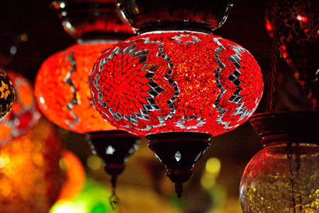 Traditional turkish lanterns lit up after dak hanging next to each otherの写真素材