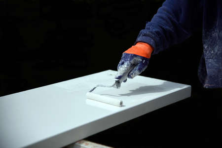 hands to work with a roller to paintの写真素材