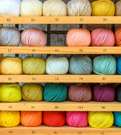 colorful wool balls in a wooden boxの写真素材