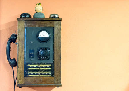 vintage telephone on wall backgroundの写真素材
