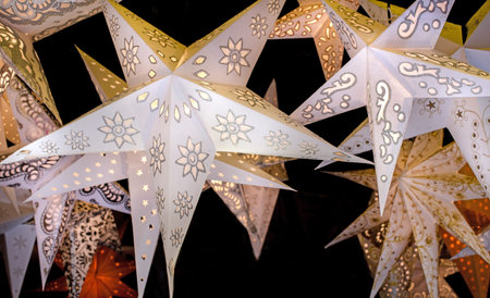 stars of paper hanging on black backgroundの写真素材
