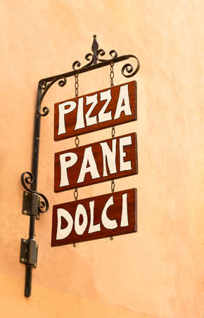 Old store sign for pizza, bread, cake in italy, wrought iron and woodの写真素材