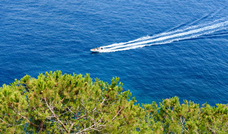 Rubber dinghy on blue seaの写真素材
