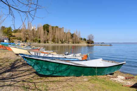 ishing boat on beach at the village of Marta, Bolsena lake, Italyの写真素材