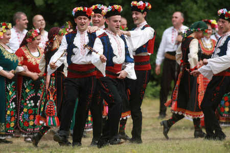 Varvara, Bulgaria - May 5, 2015: People in traditional costumes dance bulgarian horo a meadow near the village of Varvaraのeditorial素材