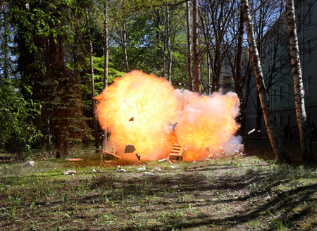 Fire from a large explosion between green trees
