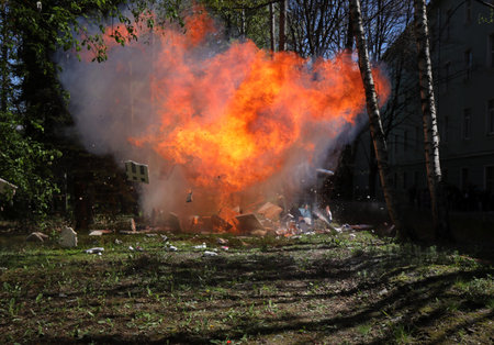 Fire from a large explosion between green trees