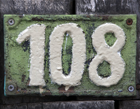 Vintage square ceramic street number plate with number. Close up, brand.