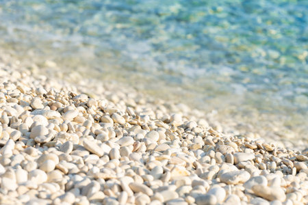 white pebble beach and turquoise water in the summer