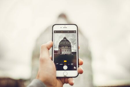 Pisa cityscape in a smart phone with architecture in Italy.の写真素材
