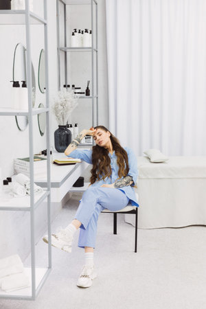 The cosmetic dermatologist's work desk is surrounded by carefully chosen accessories, plants, and books, creating a relaxing and personalized environment for her patients.の写真素材