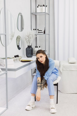 The cosmetic dermatologist's work desk is surrounded by carefully chosen accessories, plants, and books, creating a relaxing and personalized environment for her patients.の写真素材