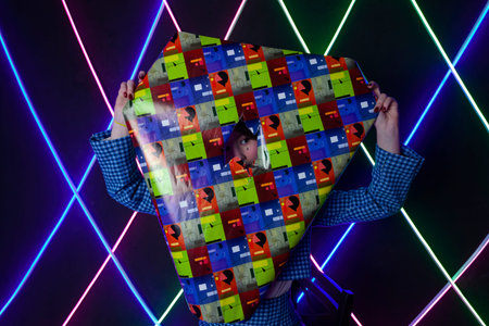 Portrait of a cute girl with drawn tears, dressed in a blue plaid jacket,  peeking out from a cutout...
