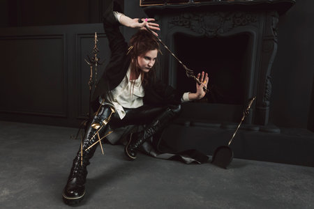Portrait of a Mystical or magical girl with a gothic make-up and auburn hair, dressed in a long...
