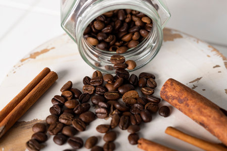 Close-up of a coffee beans and cinnamon sticks on a white background.の写真素材