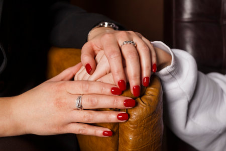 Close-up shot of a female psychologist holding the patient's hands, calming him or her down. Concept of mental health and therapy.の写真素材