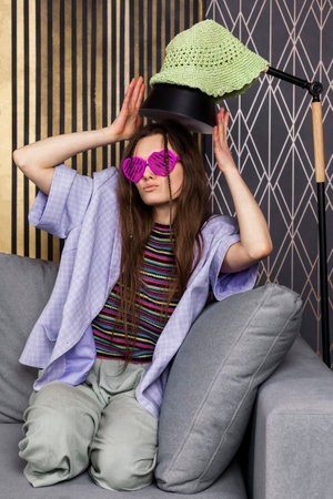 A pretty hippie girl in a heart shaped glasses.の写真素材