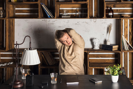 Young businessman concentrating hard on difficult computer task working in office looking stressed. Office Conceptの写真素材