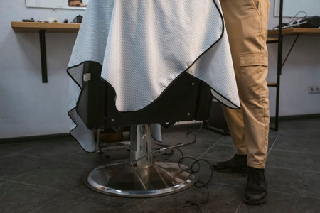 Bottom view of a barber working and a client sitting in a chair.の写真素材