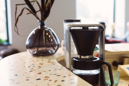 Close up of a filter coffe machine on a bar counter in a cafe or cafeteria.の写真素材