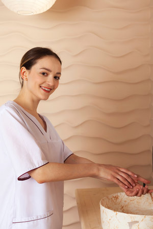 Young woman washing hands. Professional and experienced masseuse.の写真素材