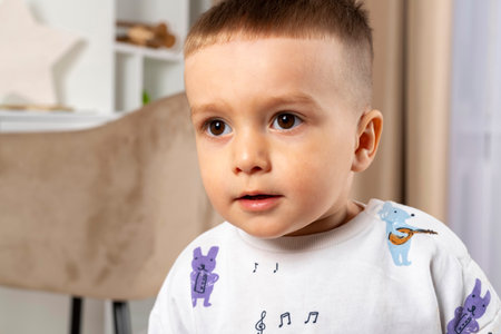 Portrait of a charming little baby boy in a white sweatshirt.の写真素材