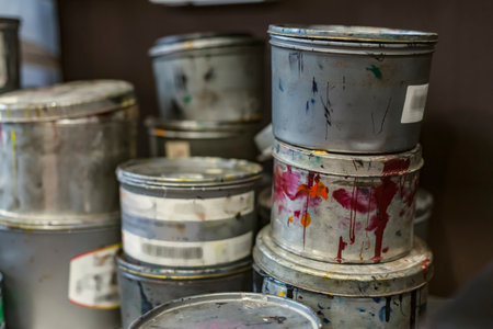 Paint tin buckets in an art studio for creating lithography.の写真素材