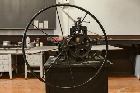 An old vintage lithographic press or rolling press used for creating lithography, or a machine for...