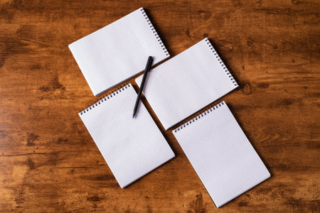 Modern Wood office desk table with blank notebooks and a pen. Home office. Flat lay top view copy space.の写真素材