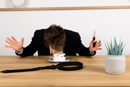 drunk businessman casually celebrating his birthday, slices and eating a cake, made a messの写真素材