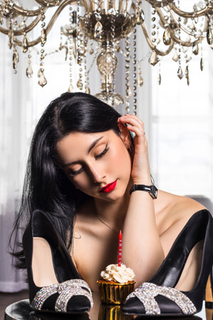 portrait Elegantly dressed young beautiful girl with black hair and dress celebrating 18th birthday. formal party meeting celebrating. new expensive shoes giftの写真素材