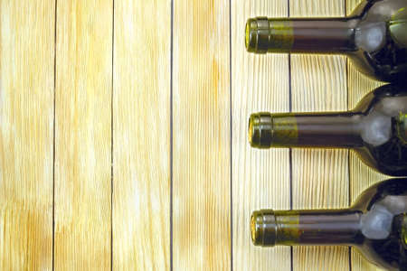 Image of wine bottles on wooden slats backgroundの写真素材