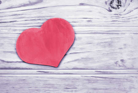 Pink heart Image which lies on the background toned wooden planksの写真素材