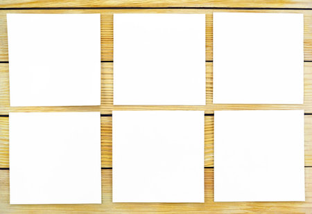 Image of white sheets of paper on the background of wooden slats