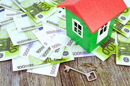 Image of a model house standing on Euro banknotesの写真素材