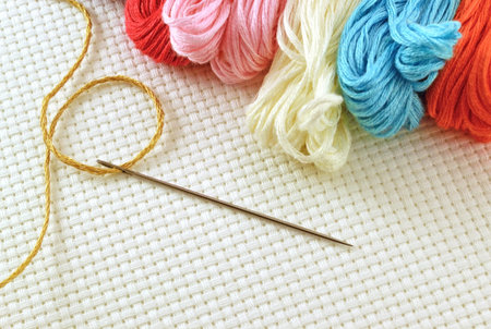 Colored threads for embroidery cross on canvas