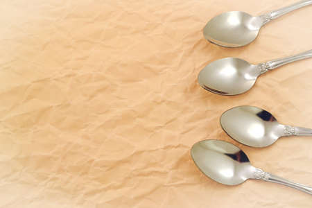 Photo spoons on a background of sheet paperの写真素材