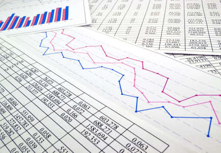 Photo diagrams graphs and numerals in the table on the paperの写真素材