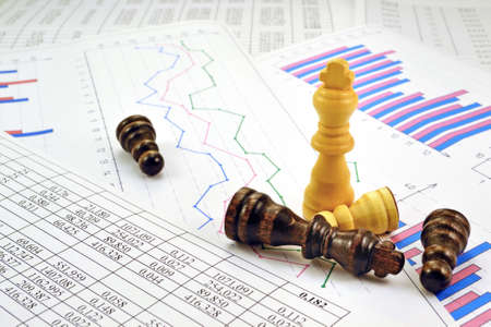 Photos chess pieces with graphs and numbers in the tablesの写真素材