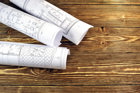 Photo drawings for the project engineering work that lie on background a wooden table