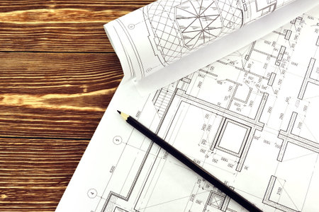 Photo drawings for the project engineering work that lie on background a wooden table
