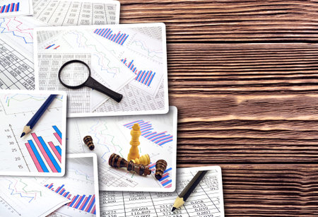 Collage of photos diagrams graphs and numerals in the table on the paperの写真素材