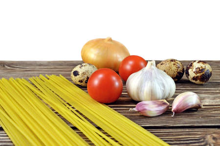 Table on which locate spaghetti with tomato garlic onion with eggs for lunchの写真素材