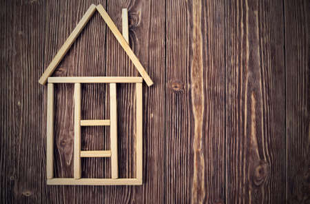 Background of wooden sticks in the form of a house and boardsの写真素材